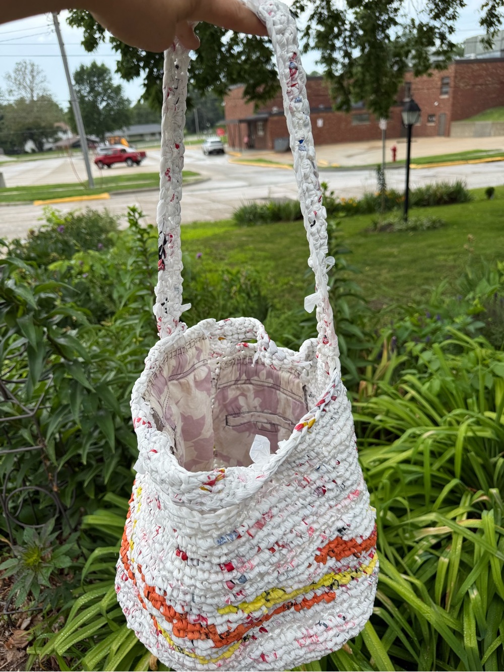 Handmade from plastic bags crocheted shopping tote bag with a pocket
